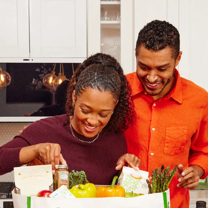 Couple unbagging FreshDirect groceries 